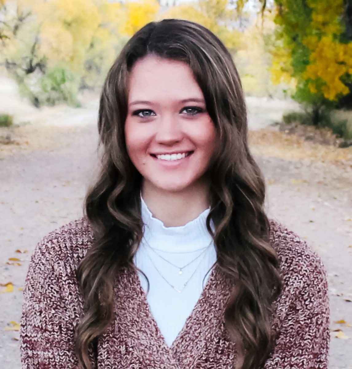Kendal Nielsen, Community Center Associate, smiling outdoors