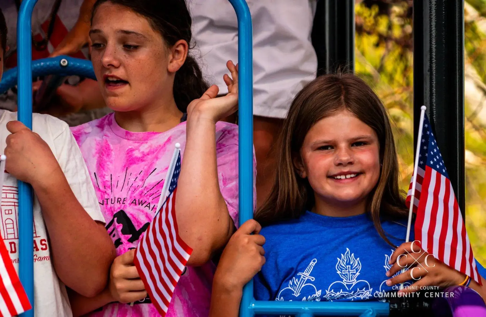 Cheyenne County families line the street as a Community Center parade float passes through downtown Sidney