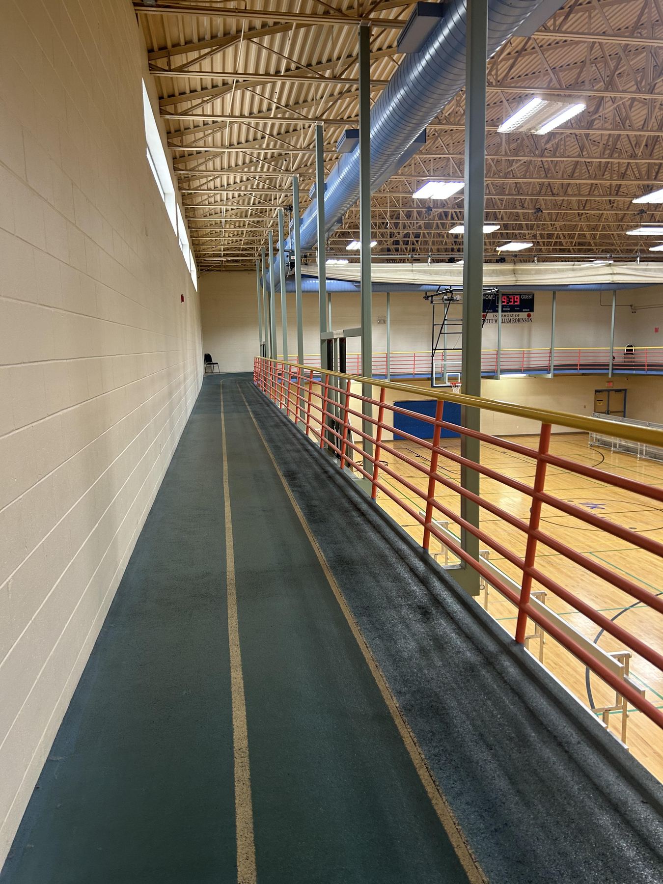 Elevated indoor walking track overlooking the gymnasium floor at The Center