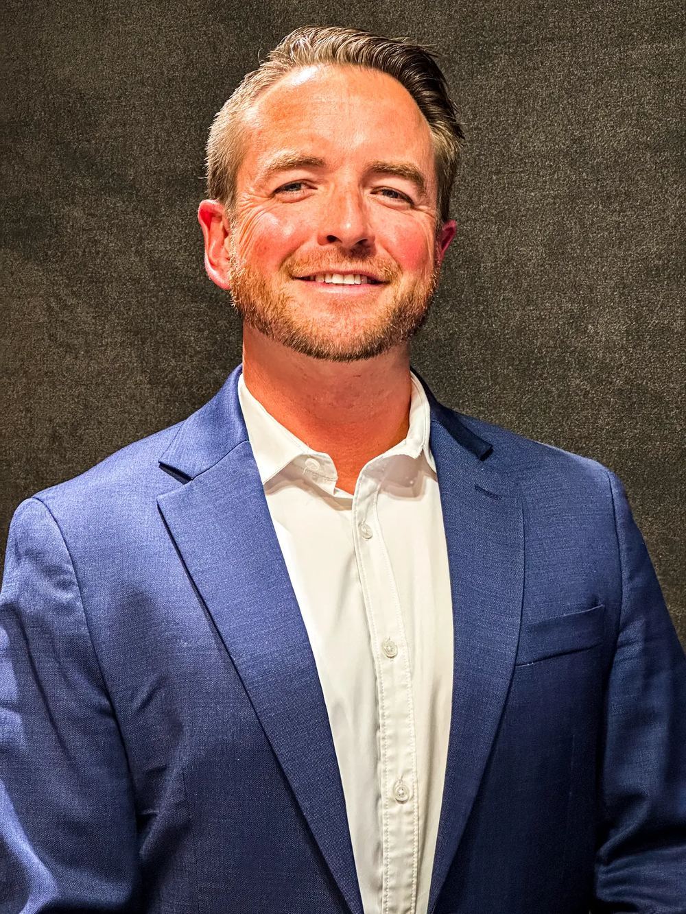 Hunter Arterburn, incoming Executive Director of The Center, wearing a blue suit jacket