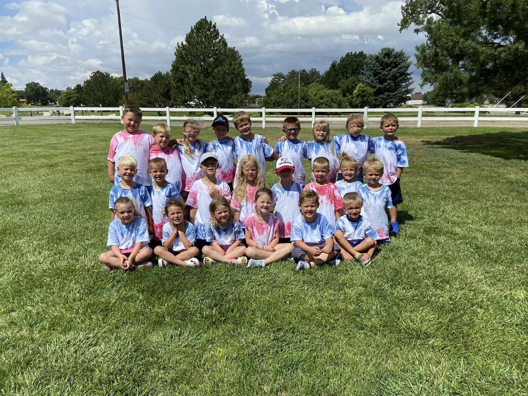 Kids Korner preschoolers in matching tie-dye shirts on the lawn at The Center