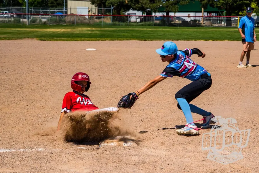 Youth baseball player applying a tag at a base during the Wood Bat Tournament