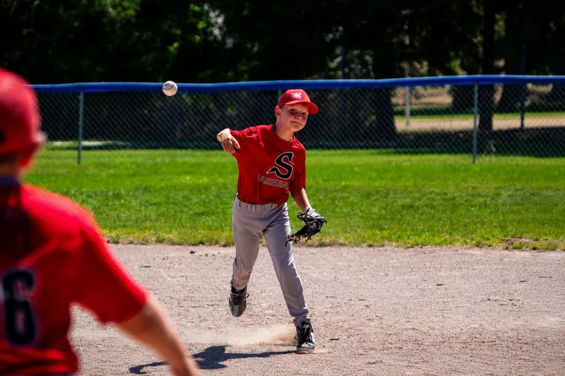 Youth baseball player throwing from the infield during a game in Sidney, Nebraska