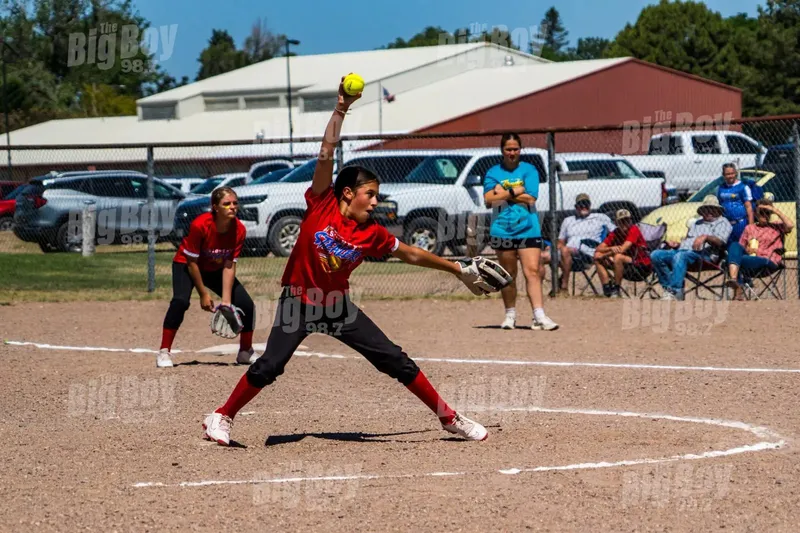 Youth softball pitcher delivering a pitch during a game in Sidney, Nebraska